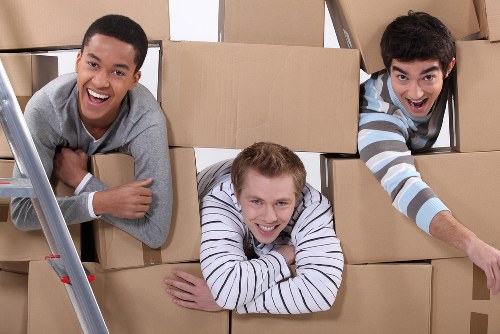 Packed moving boxes and furniture in a Balham home