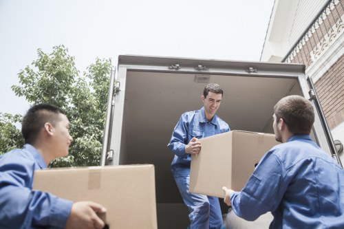 Man with van loading furniture for a move in Balham