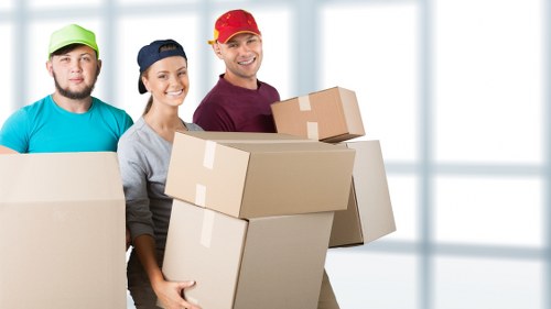 Family preparing boxes for a house removal in Balham