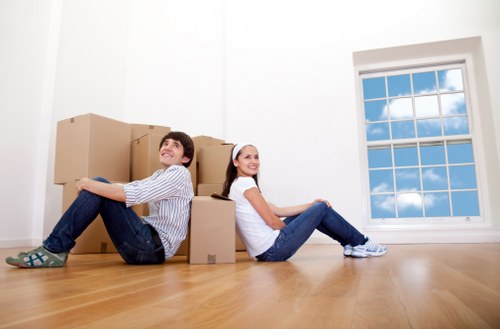 Removal team handling furniture in a Balham property